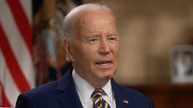 President Biden in a suit with an American flag lapel pin